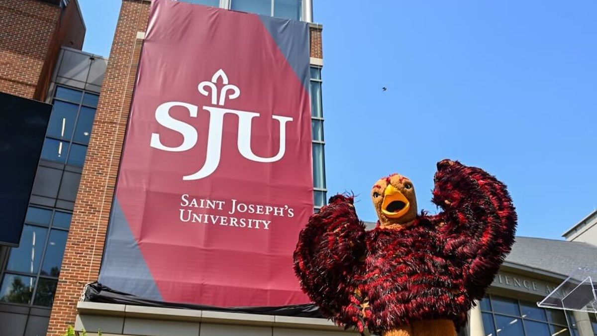 A photo of a Saint Joseph's sign at a June 1, 2022 press conference to mark the closing of its acquisition of the University of the Sciences in Philadelphia.