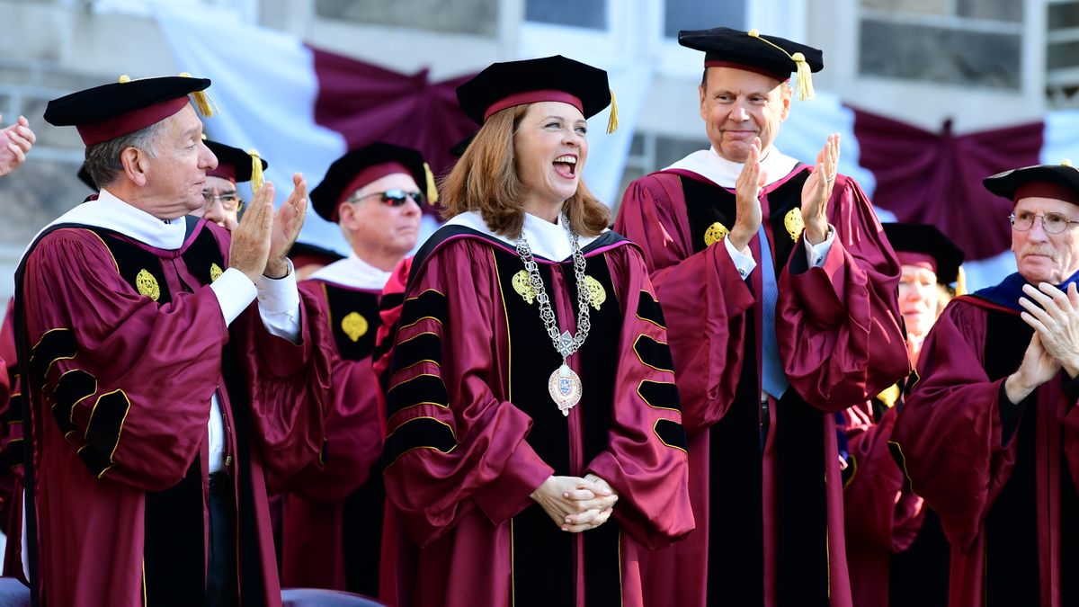 People including Fordham president Tania Tetlow wear academic regalia.